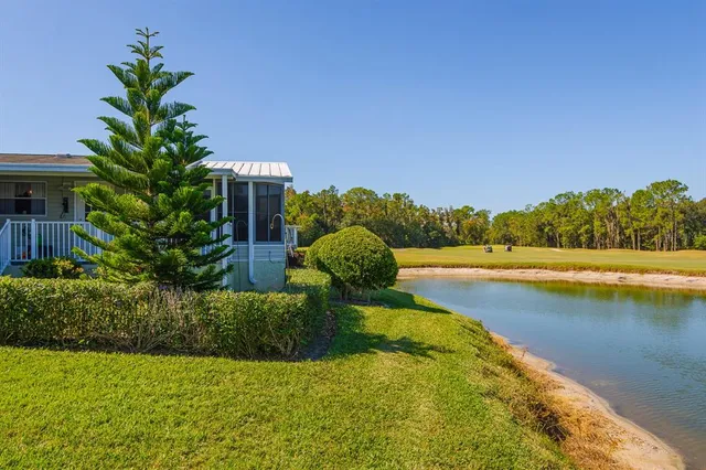 a view of a lake with a house in the background