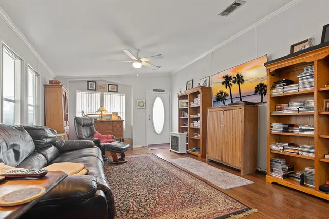 a living room with furniture a window and gym equipment