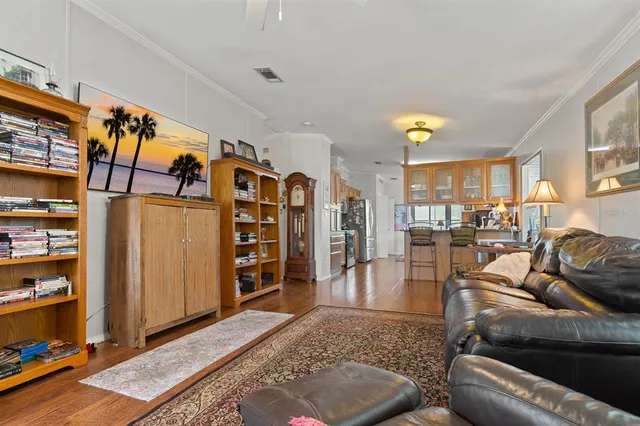 a living room with furniture and a bookshelf