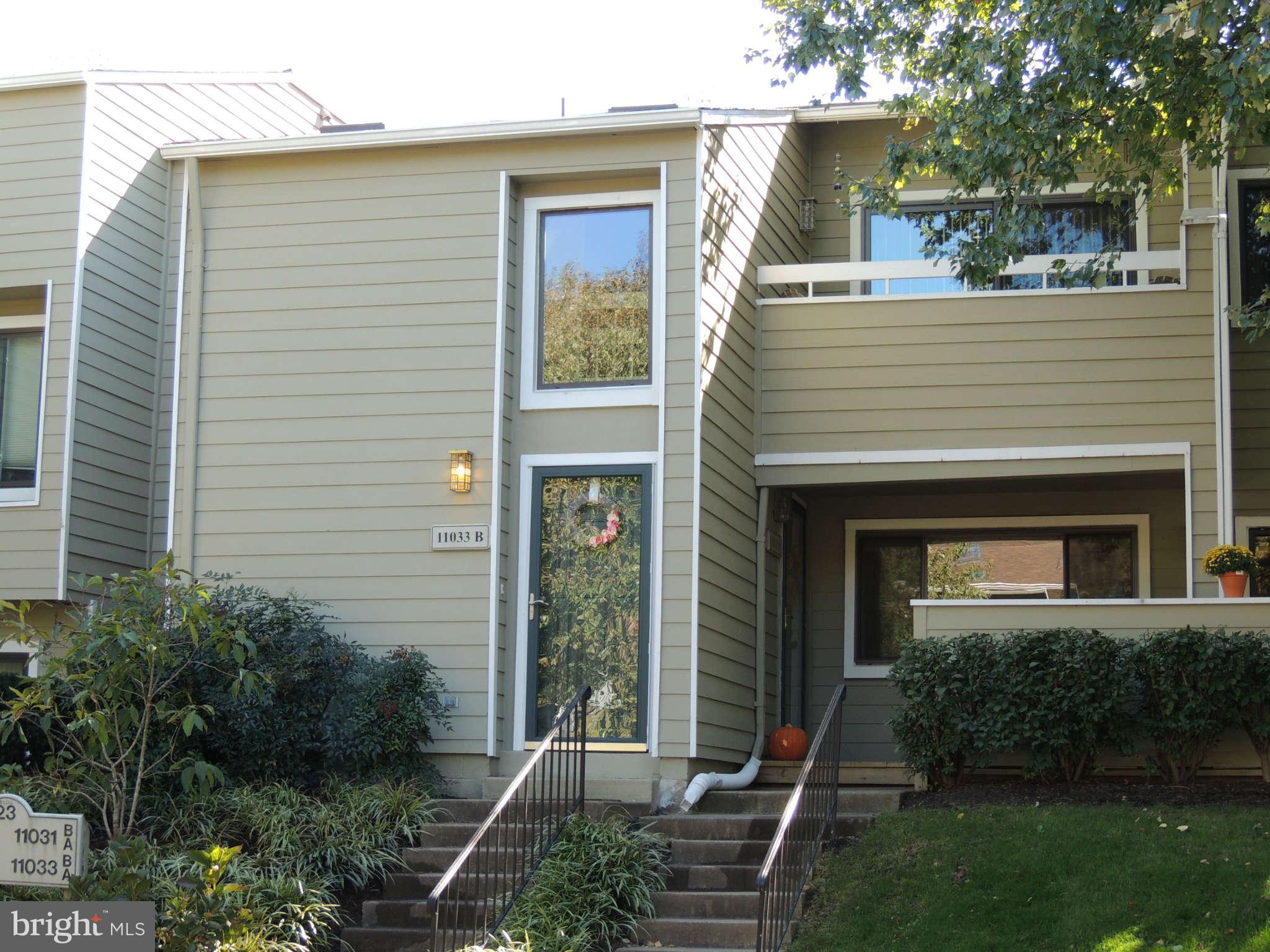 11033 Villaridge Court, Unit B Reston, VA 20191 - Photo 1 of 25 a front view of a house with a yard