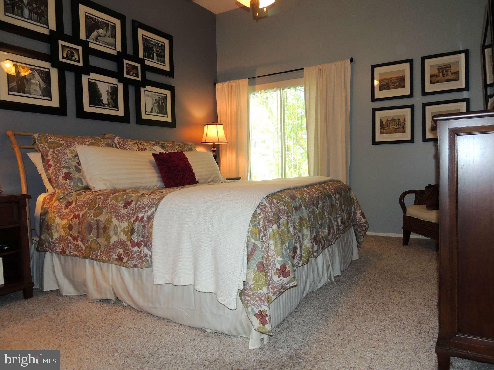 11033 Villaridge Court, Unit B Reston, VA 20191 - Photo 11 of 25 a bed sitting in a bedroom next to a window