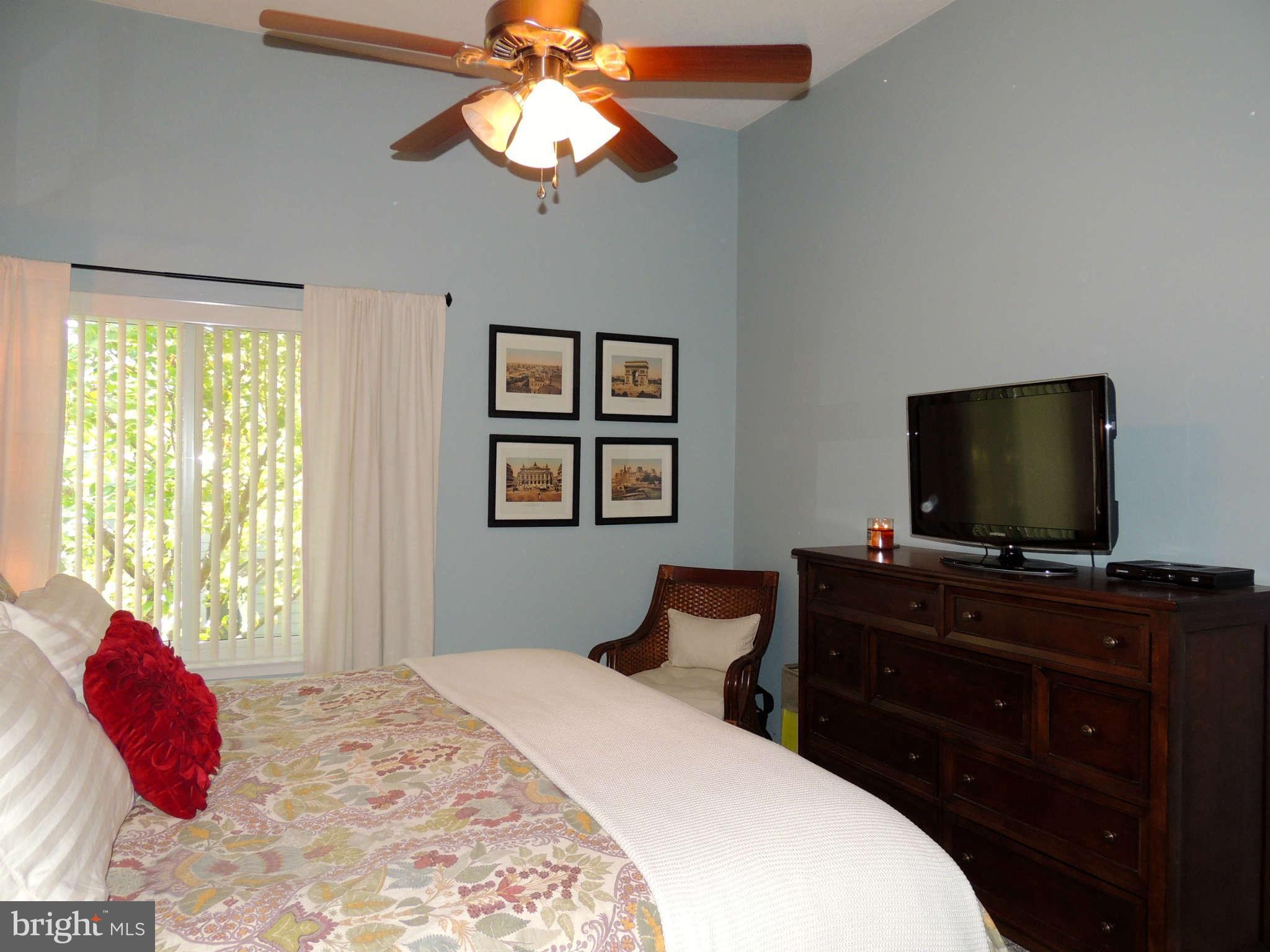 11033 Villaridge Court, Unit B Reston, VA 20191 - Photo 12 of 25 a bedroom with a bed and a flat screen tv