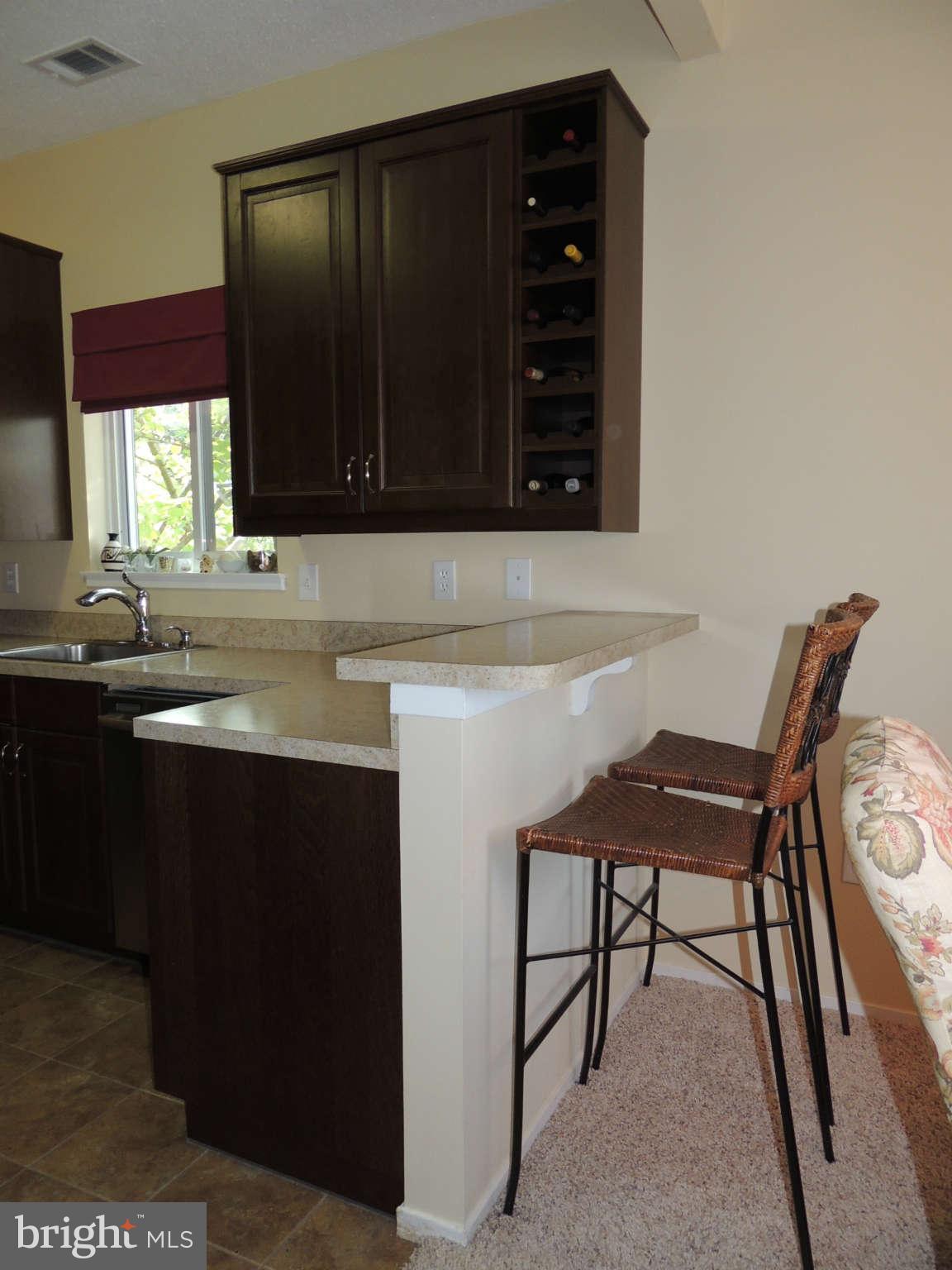 11033 Villaridge Court, Unit B Reston, VA 20191 - Photo 8 of 25 a kitchen with a table and chairs in it