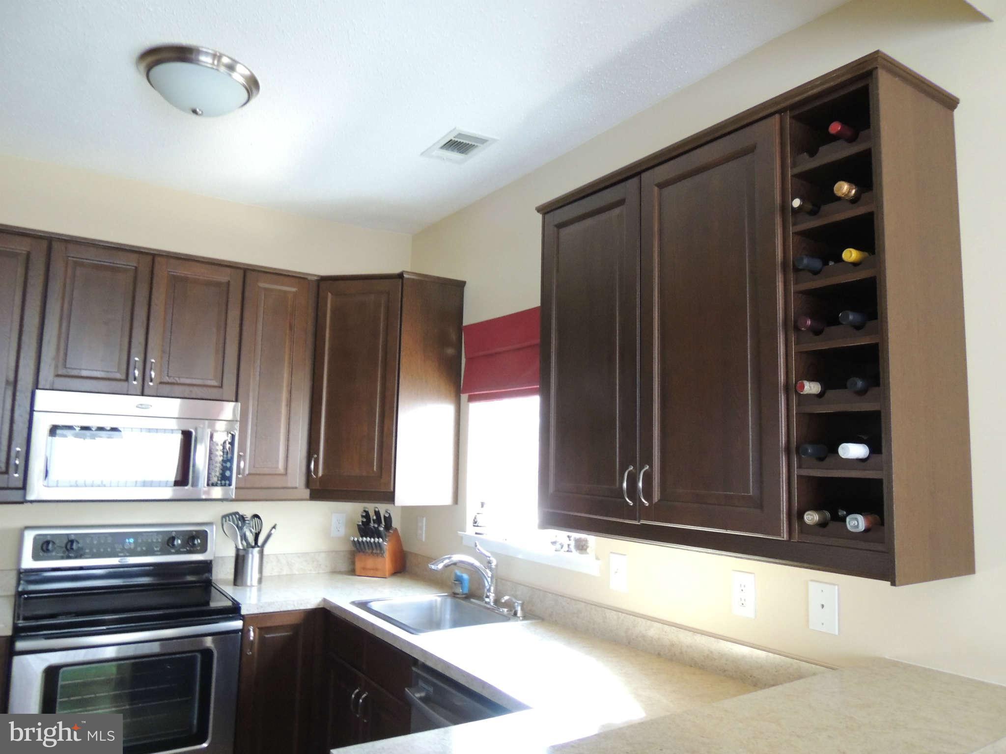 11033 Villaridge Court, Unit B Reston, VA 20191 - Photo 9 of 25 a kitchen with a refrigerator stove and cabinets