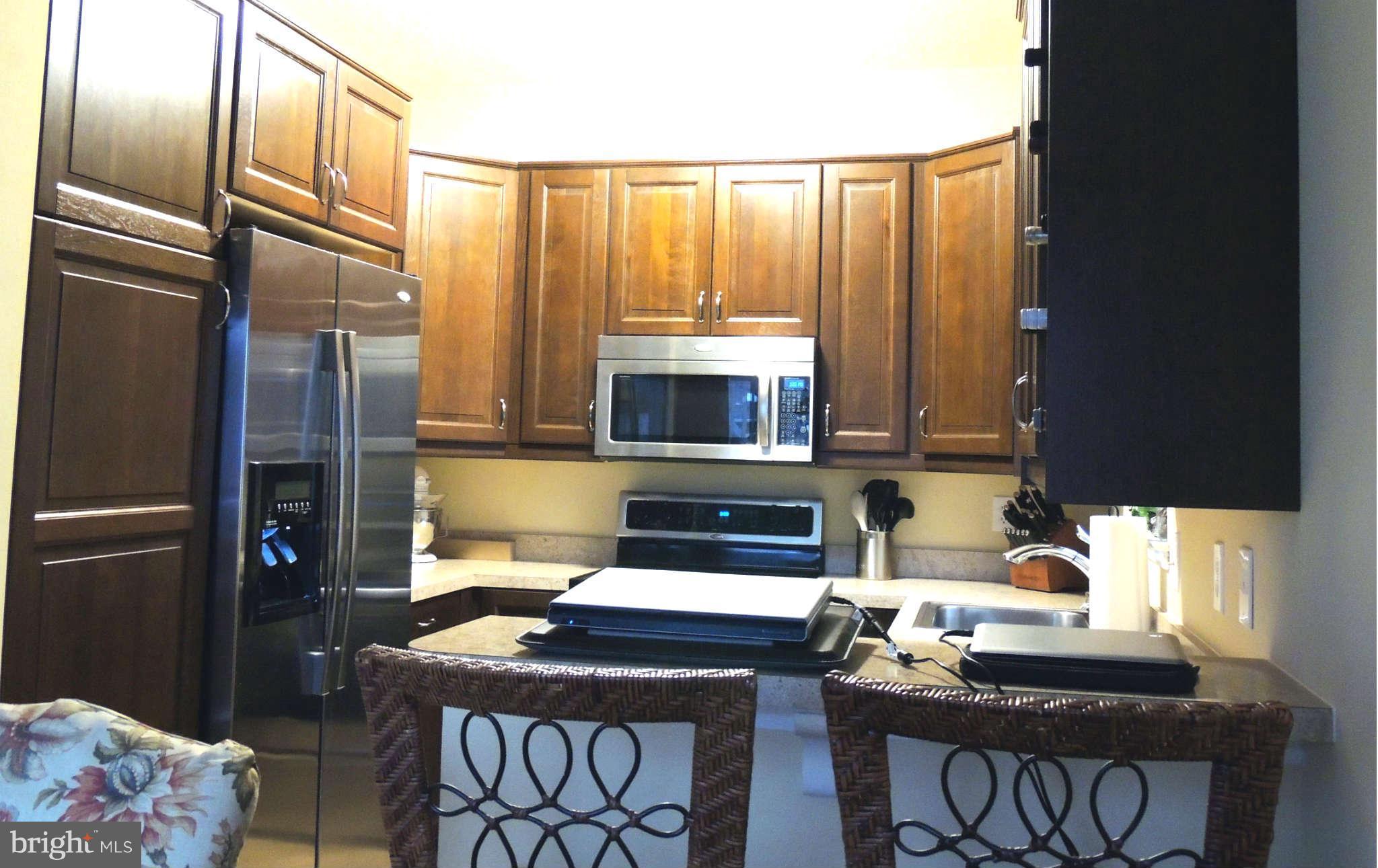 11033 Villaridge Court, Unit B Reston, VA 20191 - Photo 10 of 25 a kitchen with stainless steel appliances a stove microwave and a refrigerator