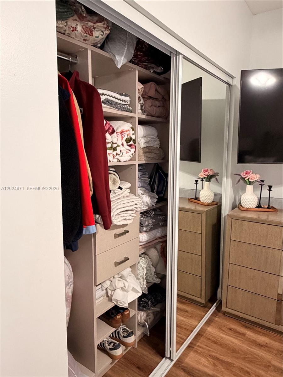 2116 Northeast 38th Road, Unit 2116 Homestead, FL 33033 - Photo 23 of 31 a view of walk in closet with clothes and shoes