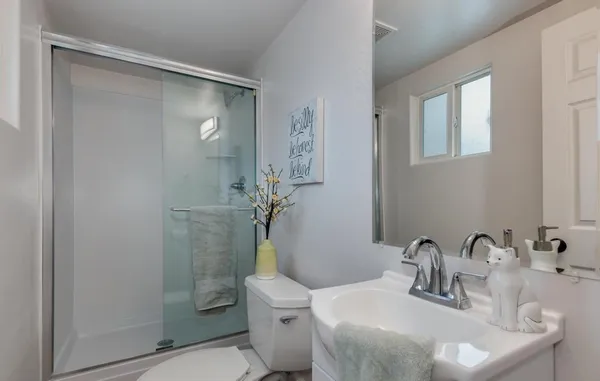 a bathroom with a sink toilet and shower