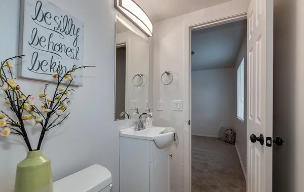 a bathroom with a toilet sink and mirror
