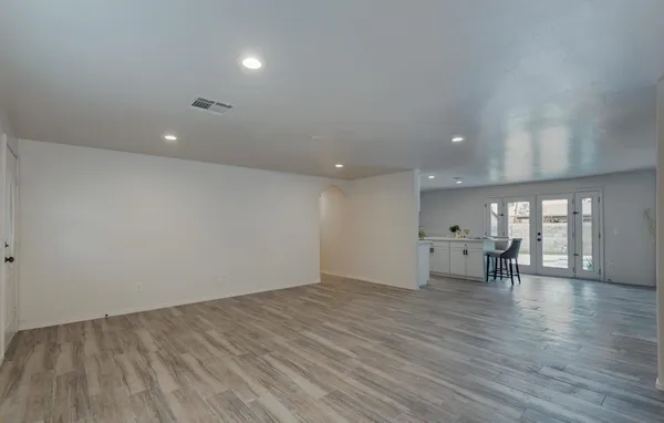 a view of empty room with wooden floor