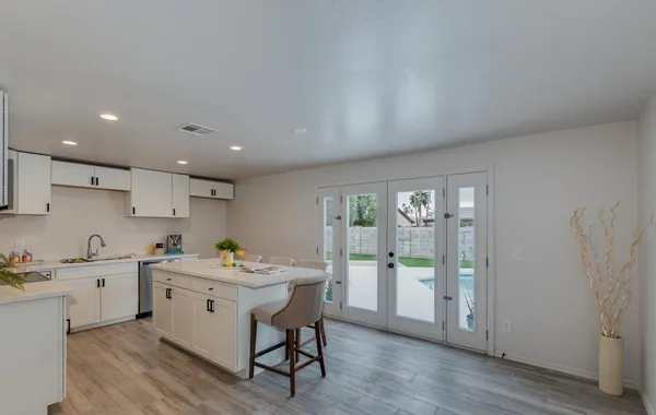 a kitchen with a sink window and cabinets