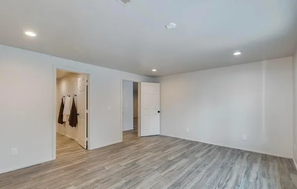 a view of hallway with wooden floor