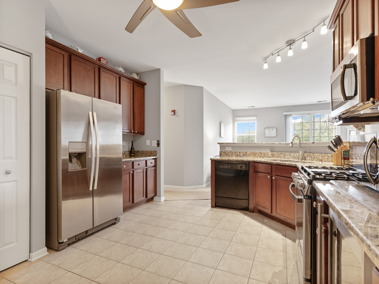 880 June Terrace, Unit 270 Lake Zurich, IL 60047 - Photo 11 of 26 a kitchen with stainless steel appliances granite countertop a refrigerator a sink a stove and oven