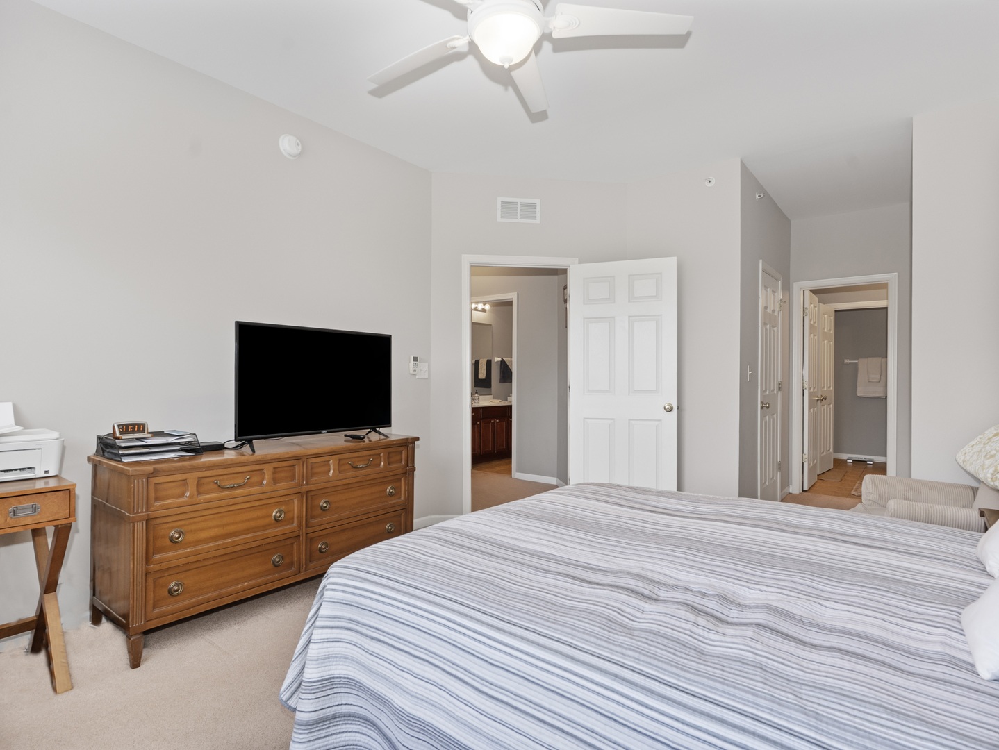 880 June Terrace, Unit 270 Lake Zurich, IL 60047 - Photo 14 of 26 a bedroom with a bed and wooden floor