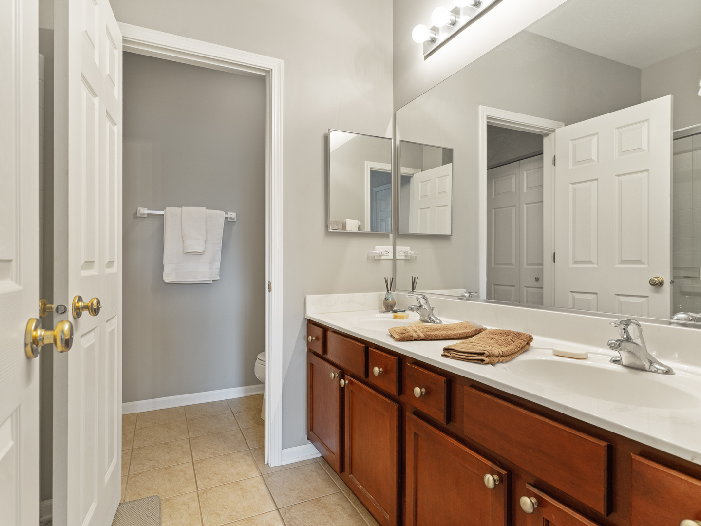 880 June Terrace, Unit 270 Lake Zurich, IL 60047 - Photo 15 of 26 a bathroom with a sink a mirror and a shower