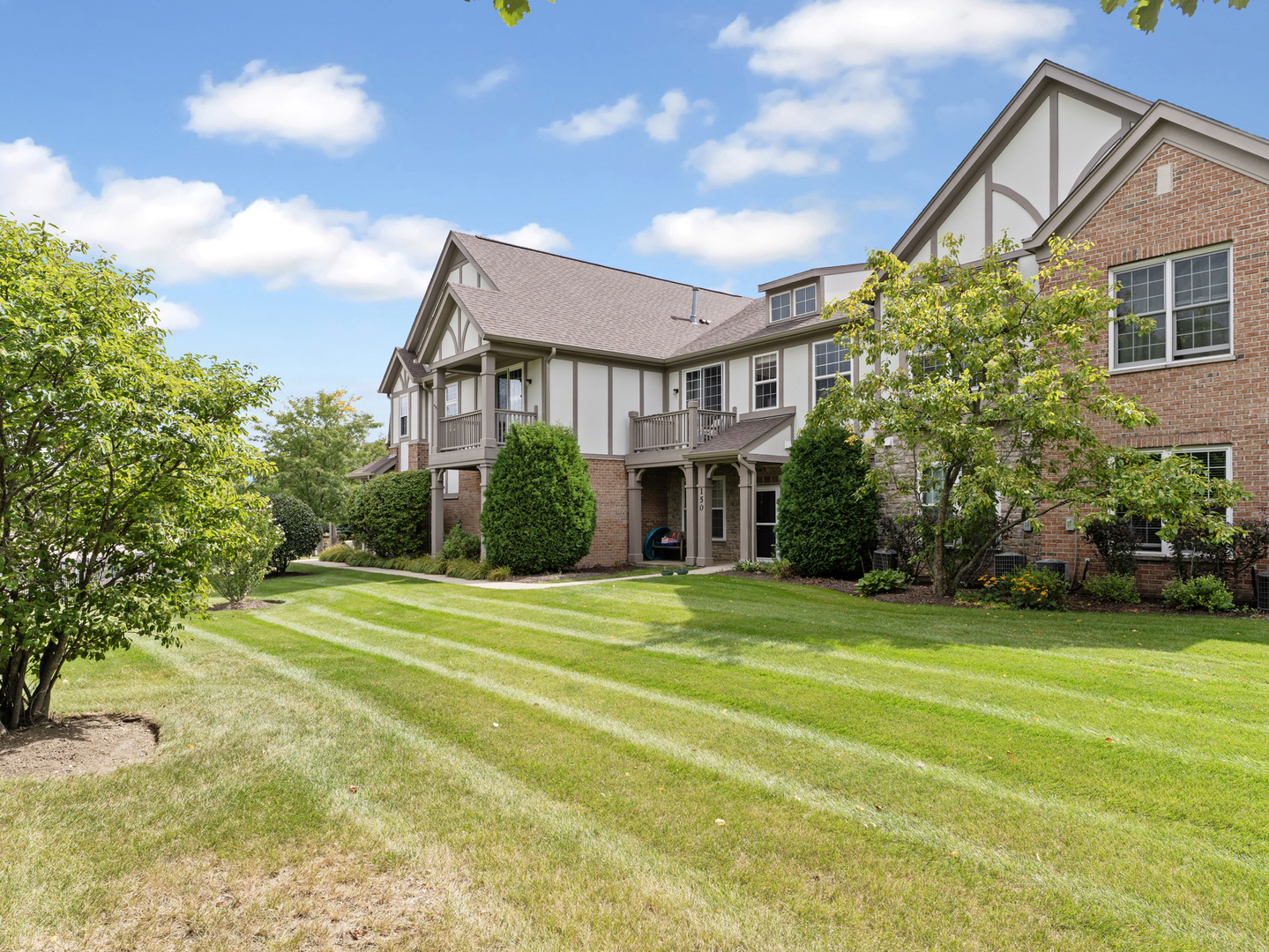 880 June Terrace, Unit 270 Lake Zurich, IL 60047 - Photo 23 of 26 a front view of a house with a garden