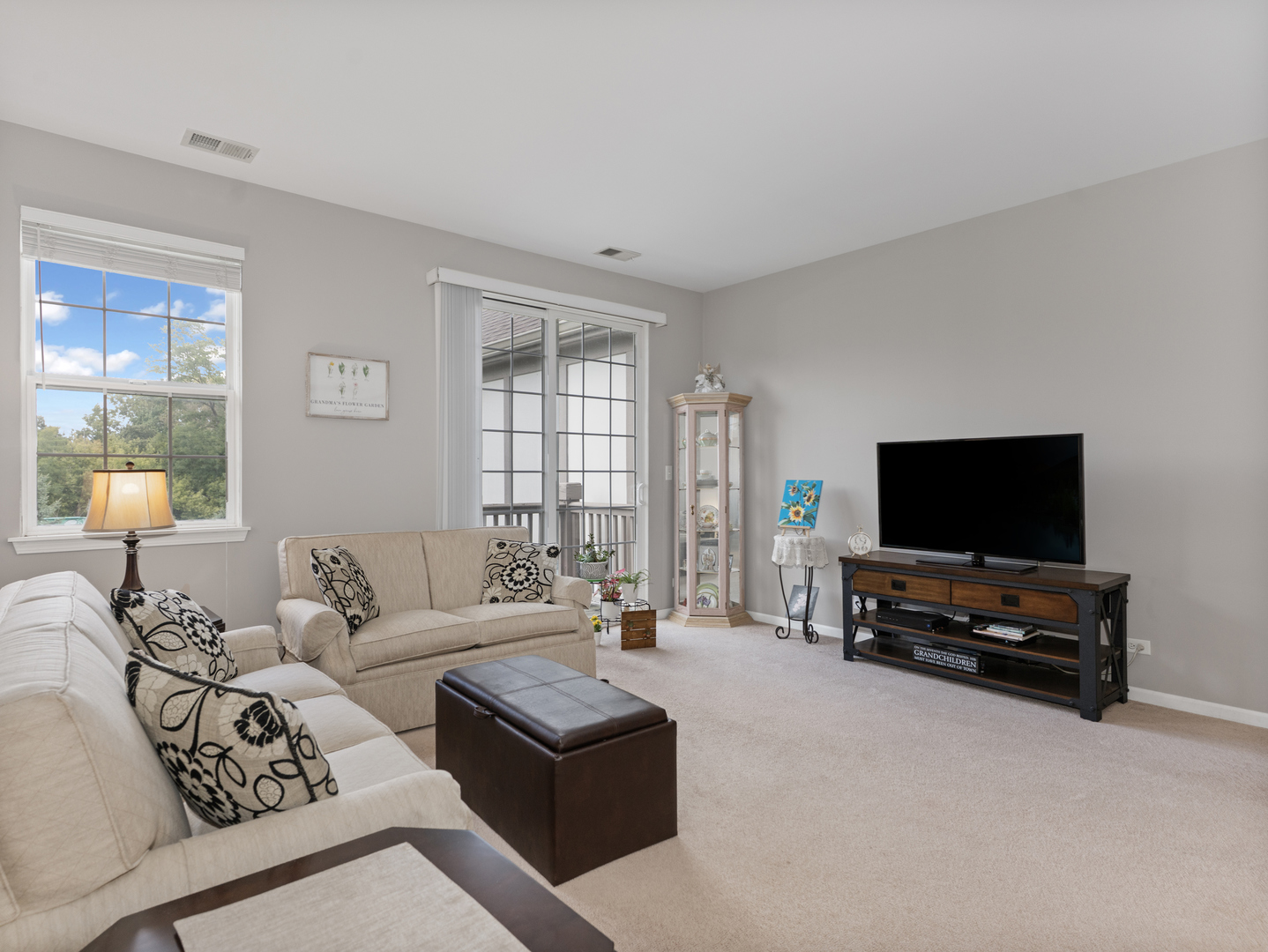 880 June Terrace, Unit 270 Lake Zurich, IL 60047 - Photo 6 of 26 a living room with furniture and a flat screen tv