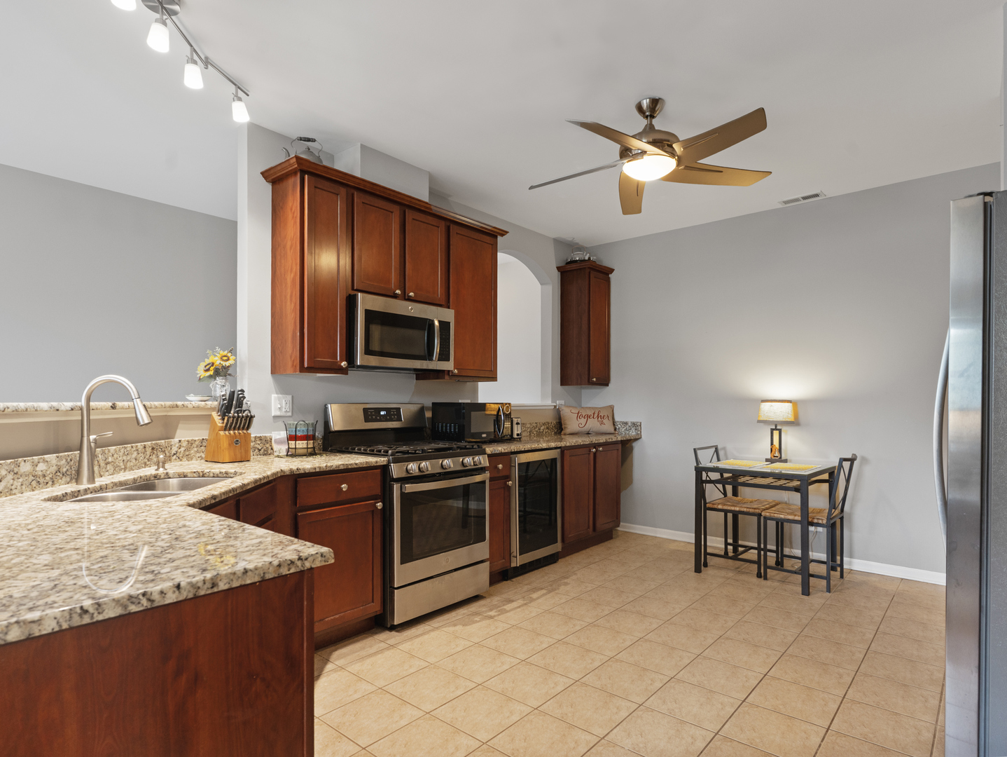 880 June Terrace, Unit 270 Lake Zurich, IL 60047 - Photo 10 of 26 a kitchen with granite countertop cabinets a sink and stainless steel appliances