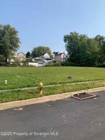 a view of a street with a yard