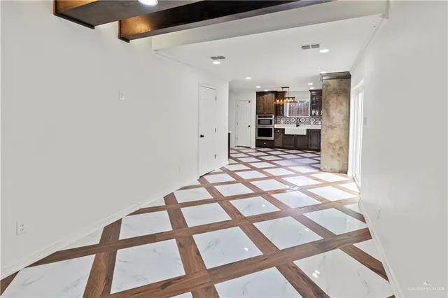 a view of a hallway with wooden floor and dining room