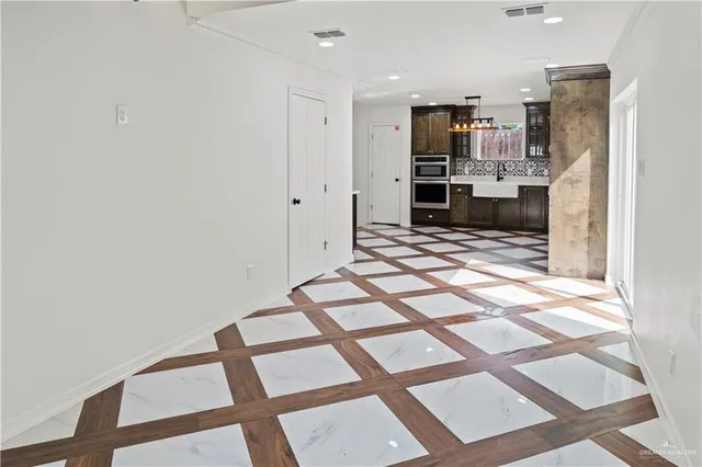 a view of a kitchen with wooden floor and a kitchen