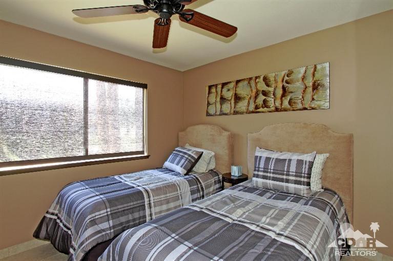 72664 Eagle Road, Unit 3 Palm Desert, CA 92260 - Photo 11 of 16 a bedroom with a bed and wooden floor