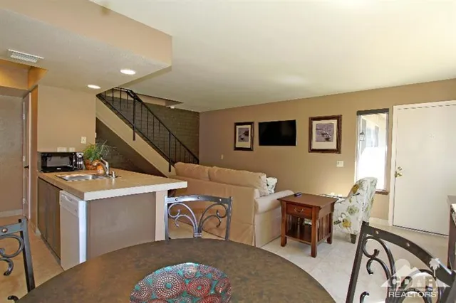 a living room with a couch and a table with wooden floor