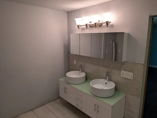 a bathroom with a sink and a mirror