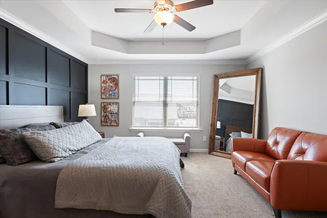 a bedroom with a bed couch and window