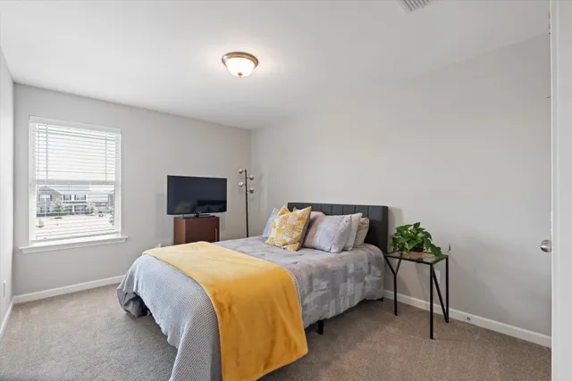 a bedroom with a bed and a window