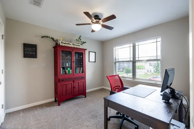 a workspace with furniture window and wooden floor