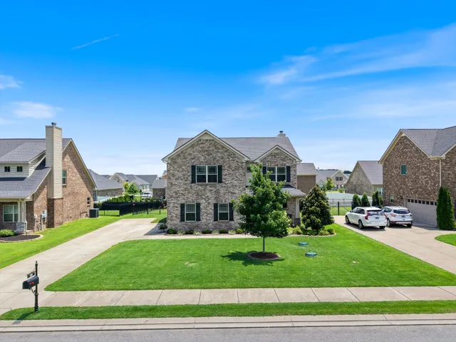 a front view of a house with a yard