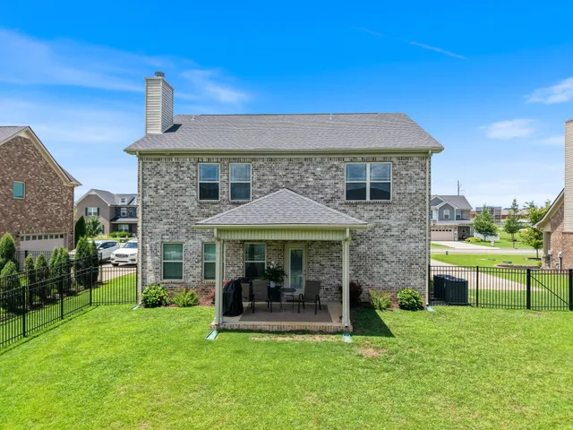 a view of a house with a yard porch and furniture