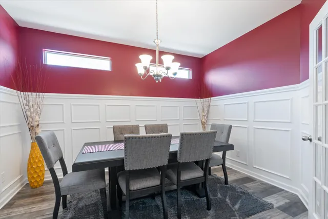 a view of a dining room with furniture and chandelier