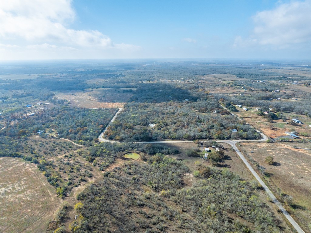 766 Bugtussle Lane Luling, TX 78648 - Photo 6 of 10 a view of a dry yard with wooden fence