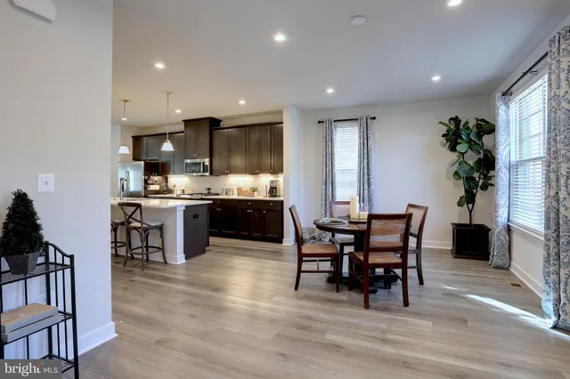 a view of a dining room with furniture and chandelier