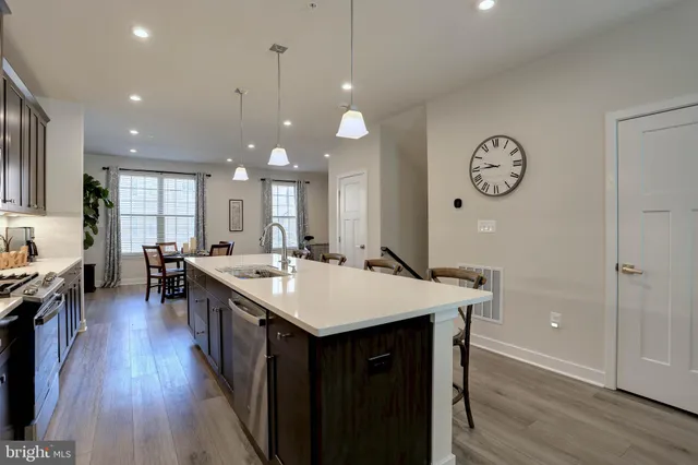 a large kitchen with a table and chairs