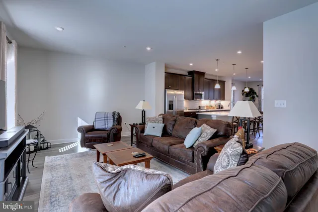 a living room with furniture and kitchen view