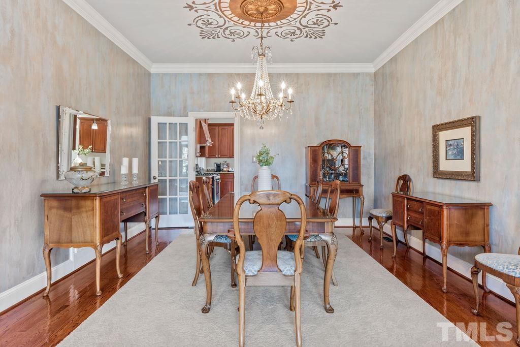 5844 Applegarth Lane Raleigh, NC 27614 - Photo 11 of 70 a view of a dining room with furniture and chandelier
