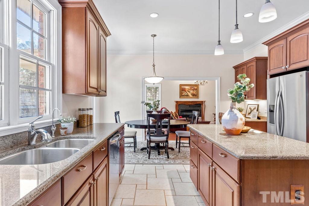 5844 Applegarth Lane Raleigh, NC 27614 - Photo 21 of 70 a kitchen with granite countertop a sink a counter top space appliances and cabinets