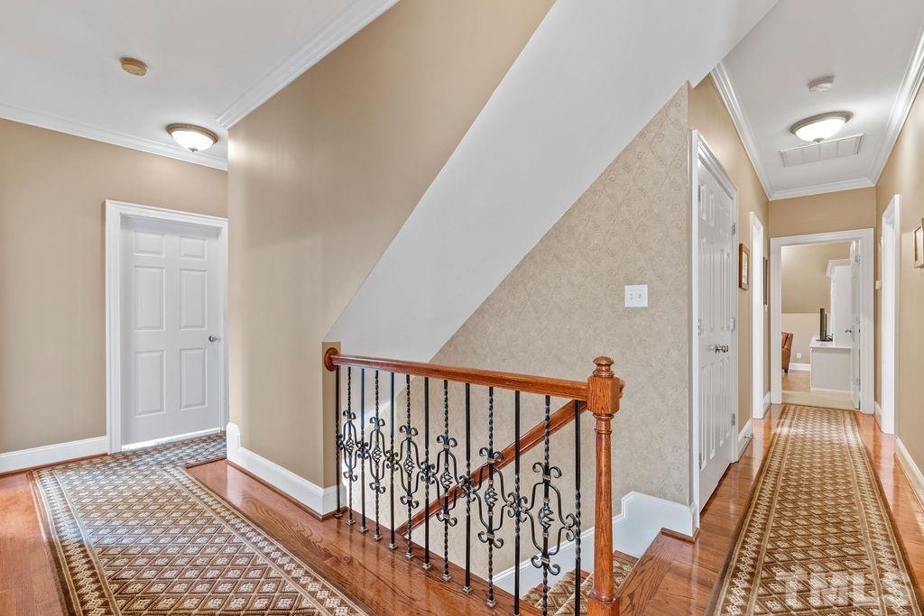 5844 Applegarth Lane Raleigh, NC 27614 - Photo 28 of 70 a view of a hallway with wooden floor and staircase
