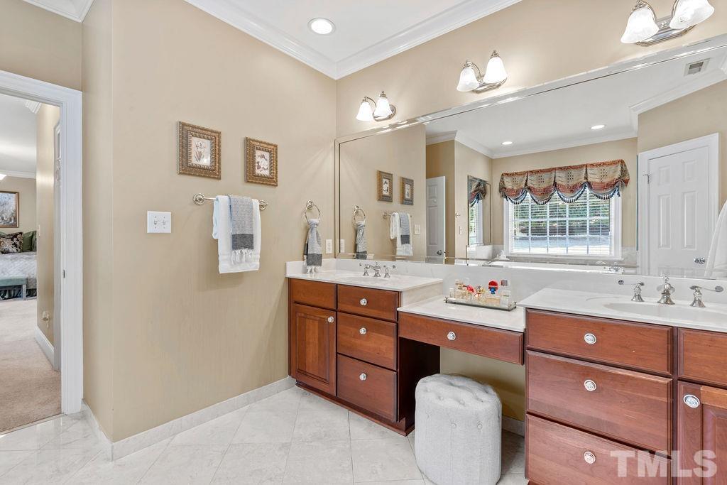5844 Applegarth Lane Raleigh, NC 27614 - Photo 32 of 70 a spacious bathroom with a granite countertop double vanity sink a mirror a window and a bathtub