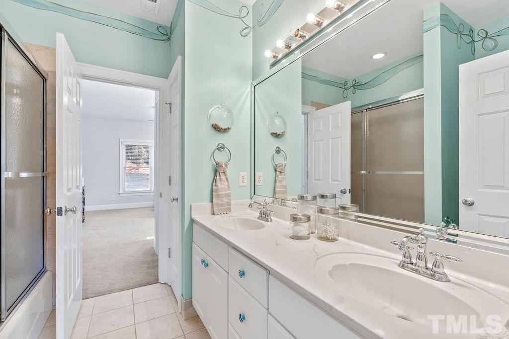 5844 Applegarth Lane Raleigh, NC 27614 - Photo 36 of 70 a bathroom with a double vanity sink mirror and double