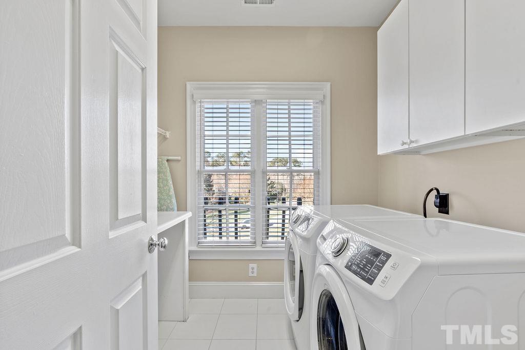 5844 Applegarth Lane Raleigh, NC 27614 - Photo 39 of 70 a view of washer and dryer with bathroom in the background
