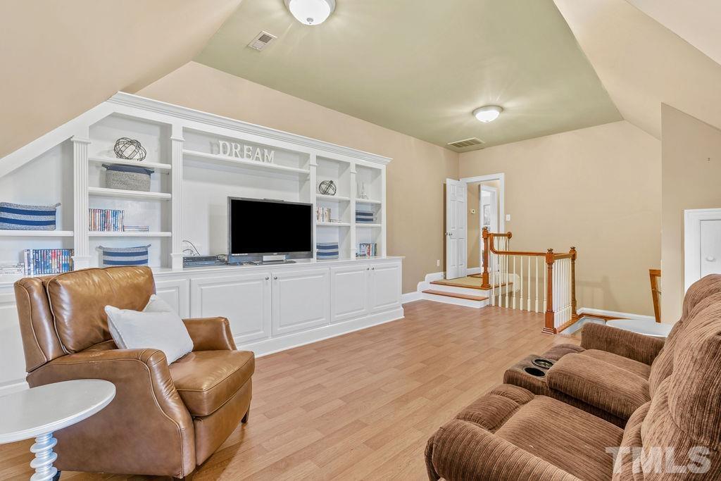 5844 Applegarth Lane Raleigh, NC 27614 - Photo 43 of 70 a living room with furniture and a flat screen tv