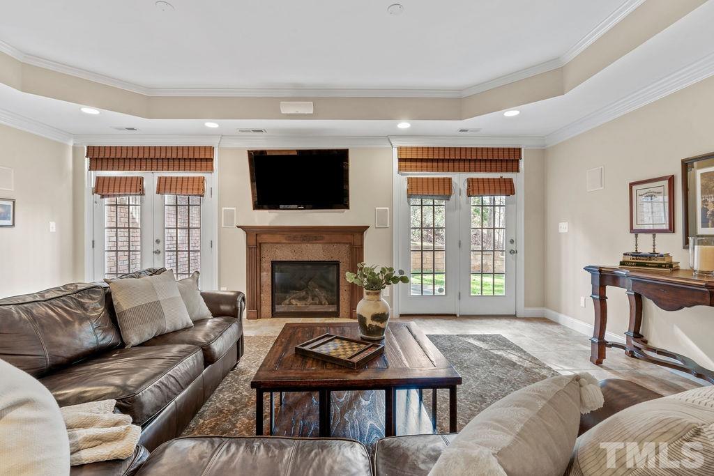 5844 Applegarth Lane Raleigh, NC 27614 - Photo 49 of 70 a living room with furniture a flat screen tv and a fireplace
