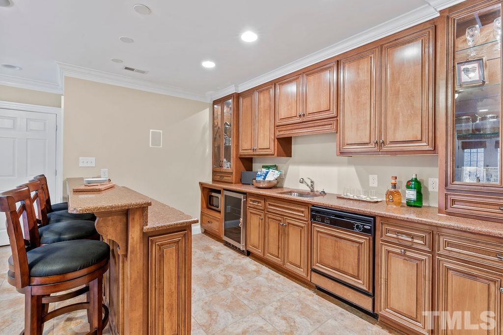 5844 Applegarth Lane Raleigh, NC 27614 - Photo 53 of 70 a kitchen with stainless steel appliances granite countertop a stove a sink dishwasher and cabinets with wooden floor