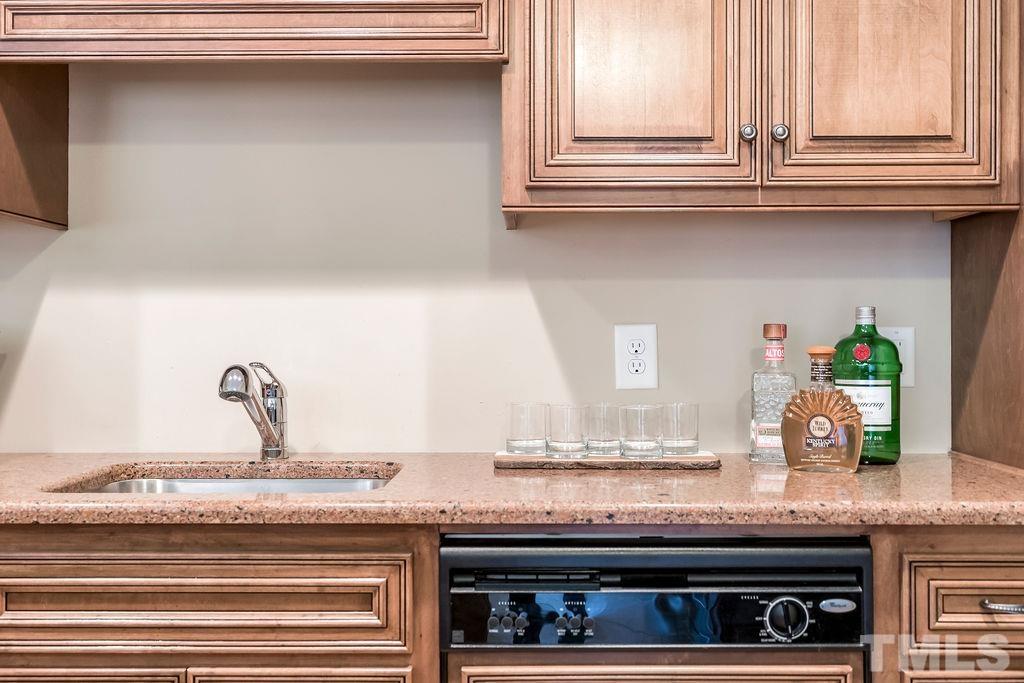 5844 Applegarth Lane Raleigh, NC 27614 - Photo 54 of 70 a kitchen with granite countertop a stove and a wooden cabinets