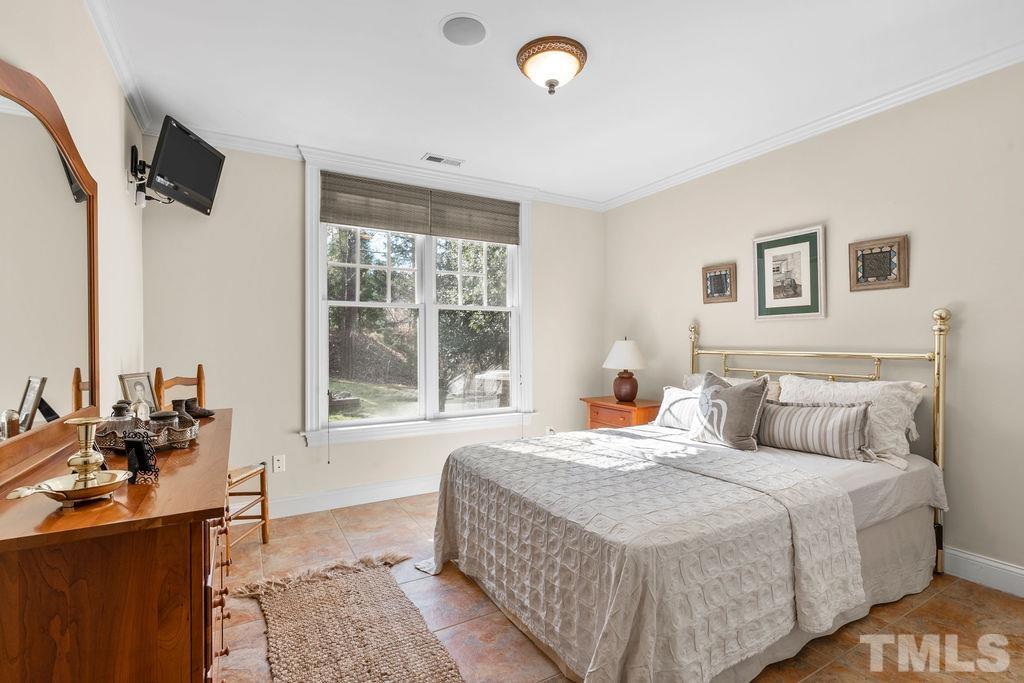 5844 Applegarth Lane Raleigh, NC 27614 - Photo 58 of 70 a bedroom with a bed and glass windows
