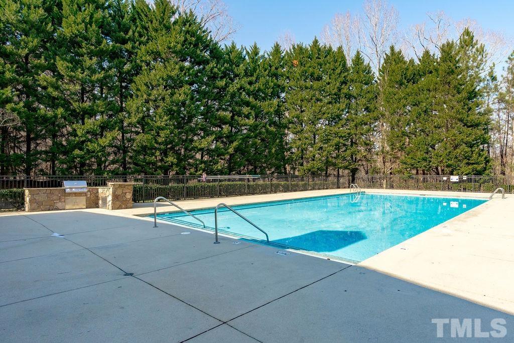 5844 Applegarth Lane Raleigh, NC 27614 - Photo 70 of 70 a view of a swimming pool with an outdoor seating and a bench
