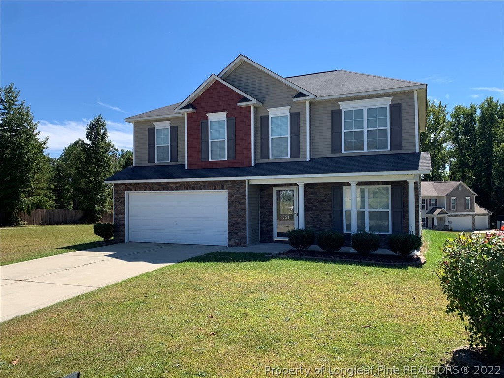 351 United Road Raeford, NC 28376 - Photo 1 of 4 a front view of a house with a yard and garage